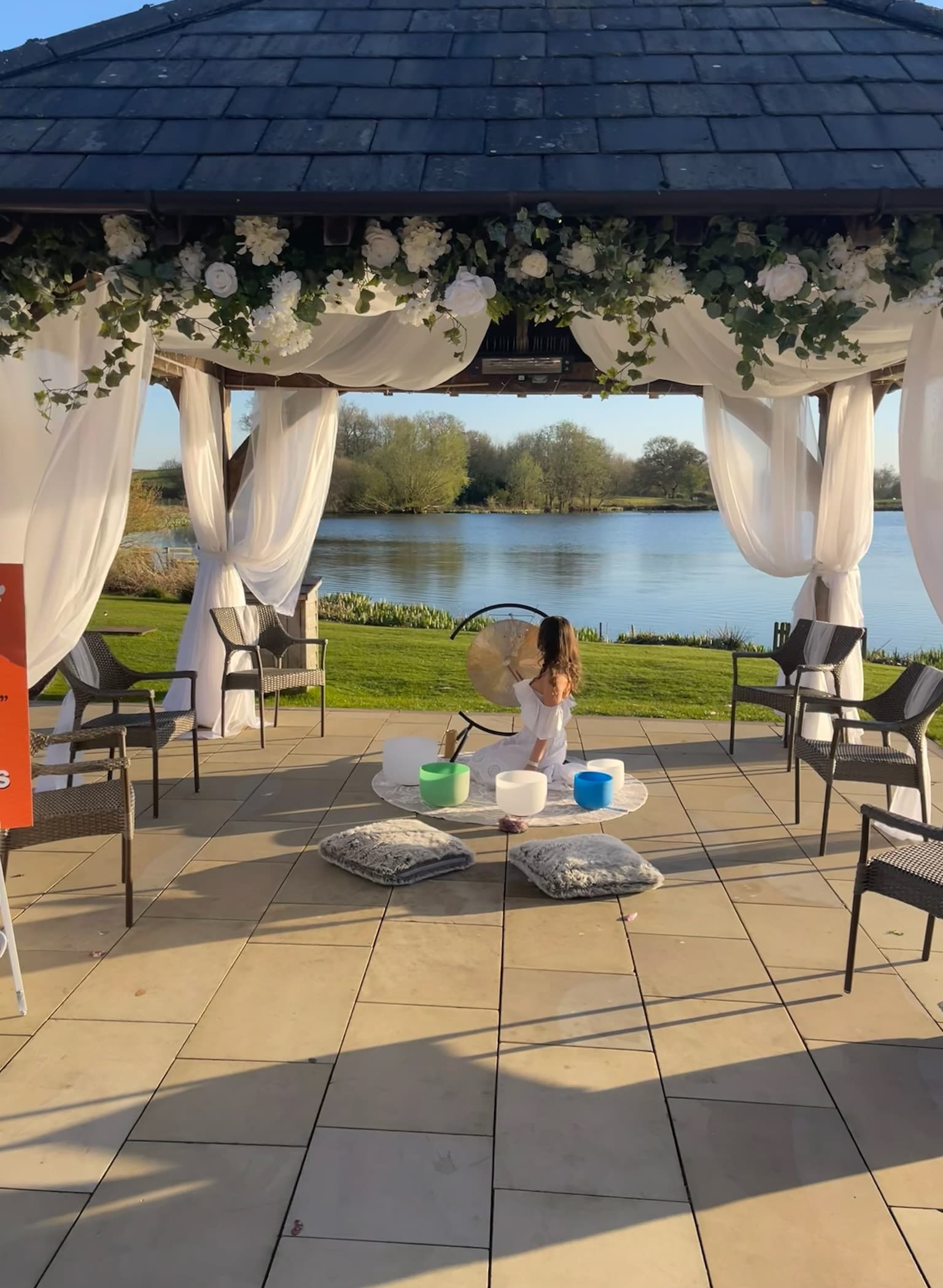 Lakeside pavilion sound bath at golden hour