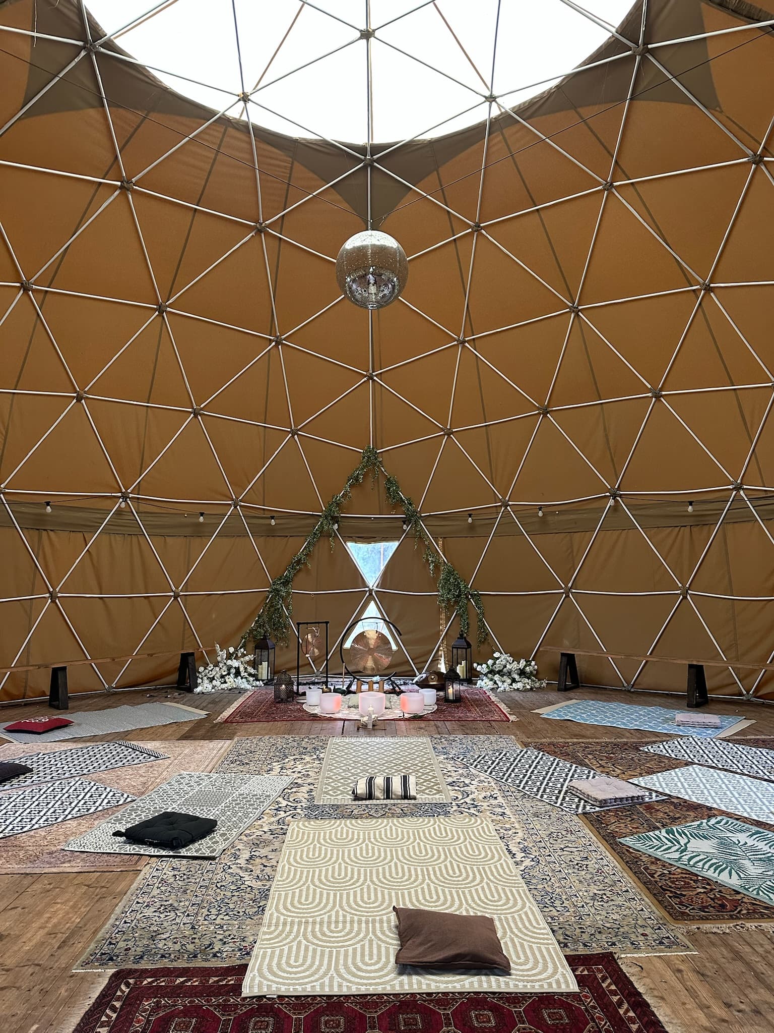 Inside the geodesic dome, candlelit sound ceremony