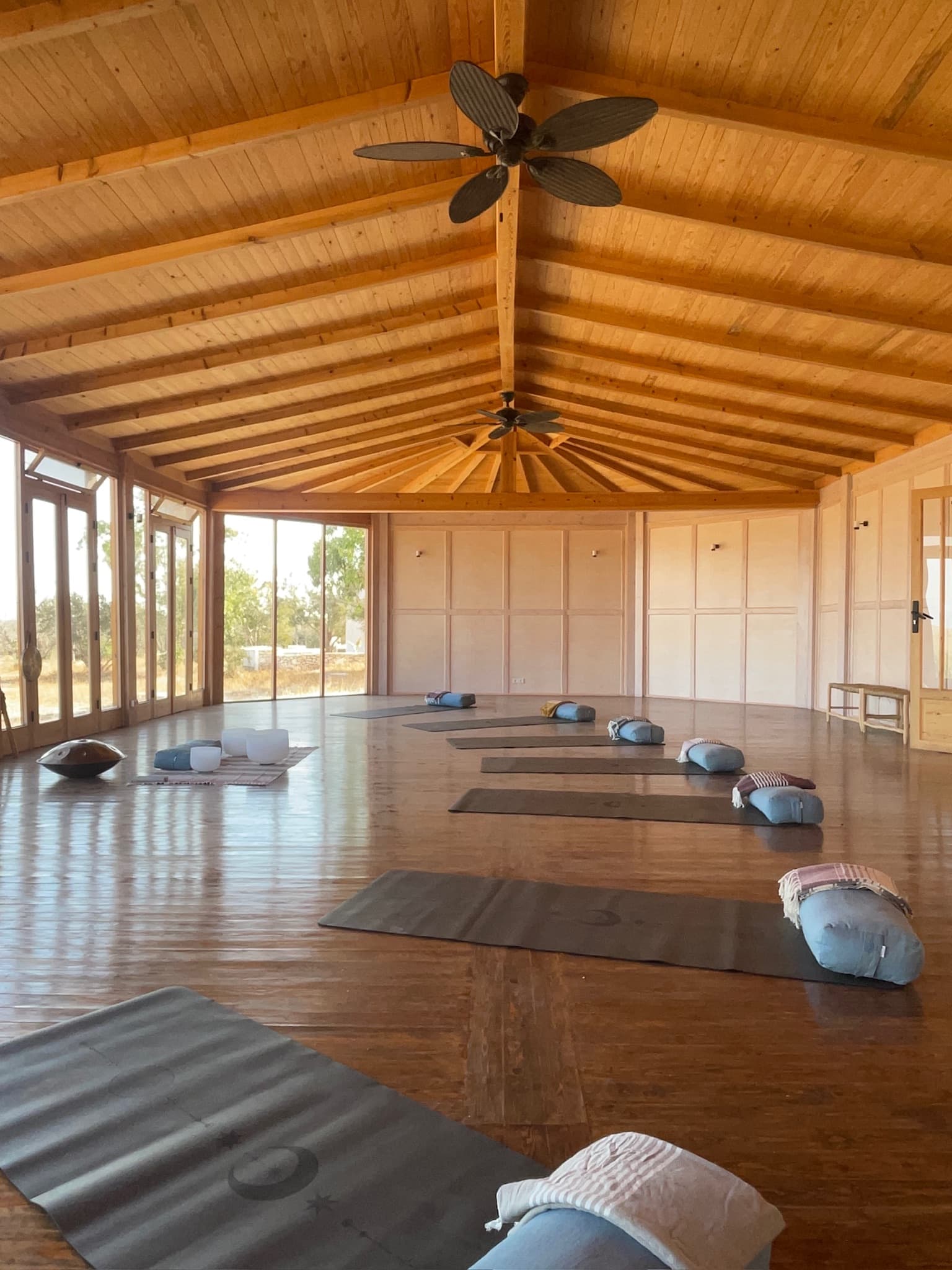 Yoga studio with wooden beams and morning light