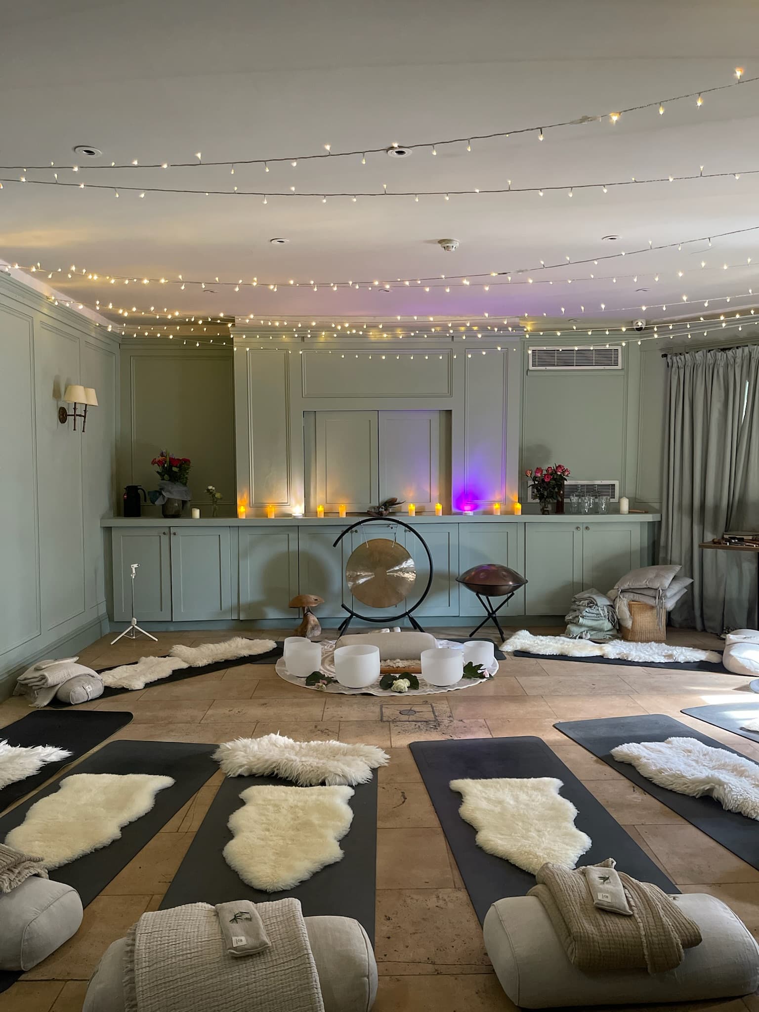 Fairy-lit sound bath with sheepskin and gong